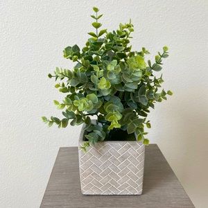 Faux plant in stone planter
